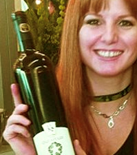Sherry Martin displaying a bottle of Karlo Estates wine