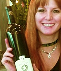 Sherry Martin displaying a bottle of Karlo Estates wine